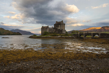 Medieval Eilean Donan Castle in Scotland. minimalist Scottish landscape of a misty morning on a calm, Loch Fada lake on the Isle of Skye, Scotland