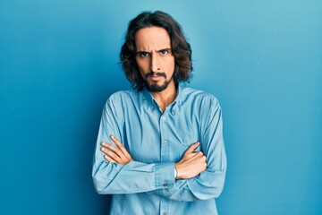 Young hispanic man wearing casual clothes skeptic and nervous, disapproving expression on face with...
