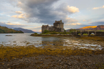 Medieval Eilean Donan Castle in Scotland. minimalist Scottish landscape of a misty morning on a calm, Loch Fada lake on the Isle of Skye, Scotland