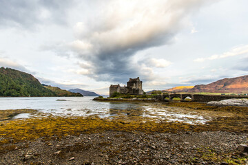 Medieval Eilean Donan Castle in Scotland. minimalist Scottish landscape of a misty morning on a calm, Loch Fada lake on the Isle of Skye, Scotland