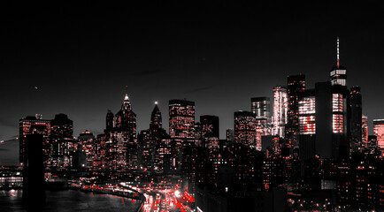 Red lights of Manhattan night skyline shining against a black and white cityscape of downtown New...