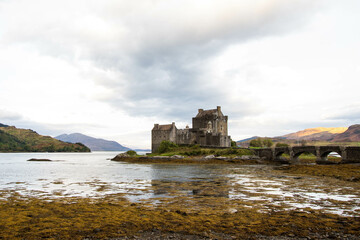 Medieval Eilean Donan Castle in Scotland. minimalist Scottish landscape of a misty morning on a calm, Loch Fada lake on the Isle of Skye, Scotland