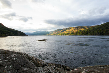 Medieval Eilean Donan Castle in Scotland. minimalist Scottish landscape of a misty morning on a calm, Loch Fada lake on the Isle of Skye, Scotland.