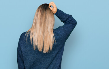 Young caucasian woman wearing casual clothes backwards thinking about doubt with hand on head