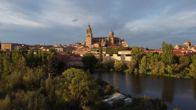 View of the Salamanca cathedral reflected in the Tormes river in Spain.