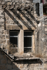 Curious and strange house facade with stairs, door, and window to nowhere, Mi'ilya Village, Western Galilee, Northern District of Israel, Israel.