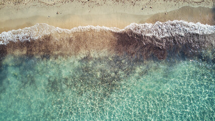 Beautiful birdsview with a drone on the beach, sand, sea and waves.