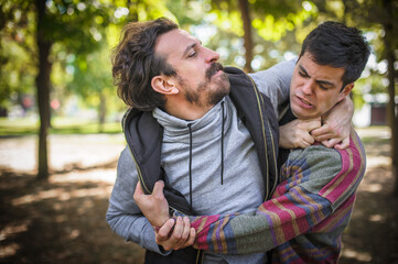 Young gay homosexual couple in physical confrontation and a fight
