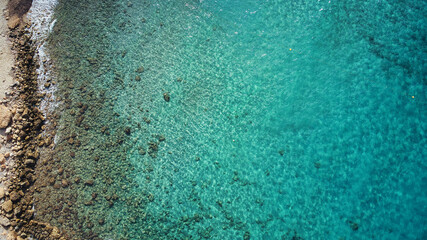 Beautiful birdsview with a drone on the beach, rocks, sand, sea and waves.