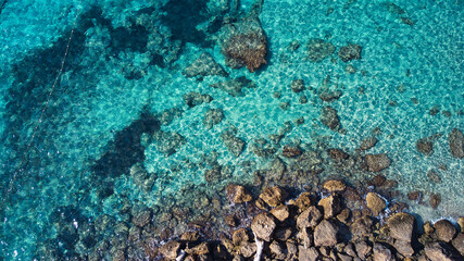 Beautiful birdsview with a drone on the beach, rocks, sand, sea and waves.