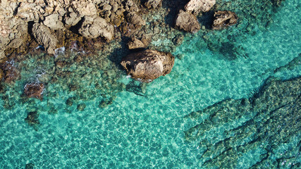 Fototapeta na wymiar Beautiful birdsview with a drone on the beach, rocks, sand, sea and waves.