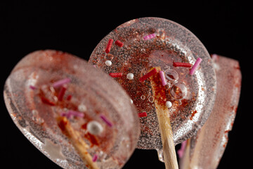 Transparent lollipops with decorations the black background