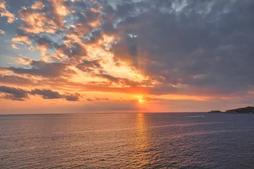 Deurstickers Beautiful sunset with a dramatic sky and clouds over the sea © Hanjin