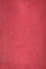 The cover of the old book is red with uneven texture.