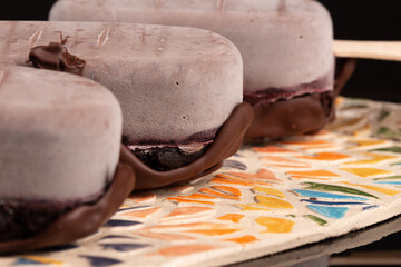 Chocolate cheese cake eskimo on pottery plate on the black background