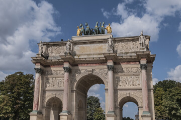 Fototapeta na wymiar Corinthian style Paris Triumphal Arch (Arc de Triomphe du Carrousel) at Place du Carrousel. The monument built between 1806 - 1808 to commemorate Napoleon's military victories. Paris, France.