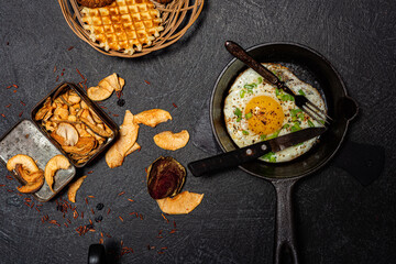 Fried egg in a cast-iron frying pan. Breakfast - kitchen utensils