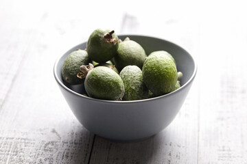 Feijoa fruits or pineapple guava in bowl on wooden table