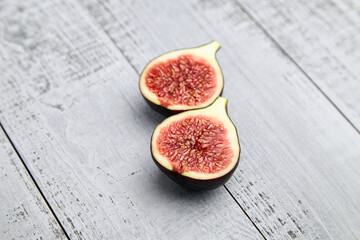 Fig fruit ripe halves on wooden table