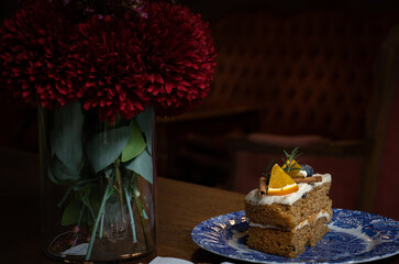 Orange carrot cake on blue patterned ceramic plate