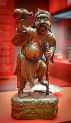 Chinese sculpture "The patron saint of winemaking Li Teguai looking into a vessel in the form of a pumpkin". Carved wood, polished, 19th century