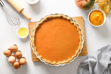 Process of making Pumpkin Pie for Thanksgiving Day on white background. Seasonal traditional autumn cake for home festive dinner. Top view.