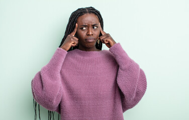 black pretty woman looking concentrated and thinking hard on an idea, imagining a solution to a...