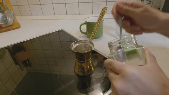 Woman puts coffee in the coffee pot to prepare it. 4k video quality