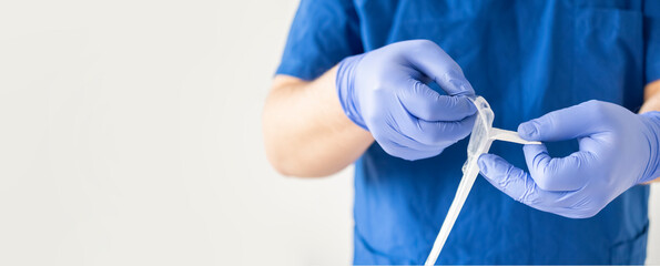 Close up researcher unpacking disposable pipette for loads DNA samples. Wide banner with copy space