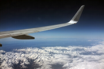 Fototapeta na wymiar view from airplane window on snowy white Pyrenees mountains