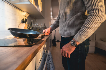 Student preparing food in his student dorm.