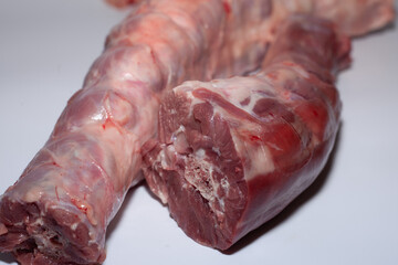 Pieces of turkey neck with bone. Organic turkey meat with greens
