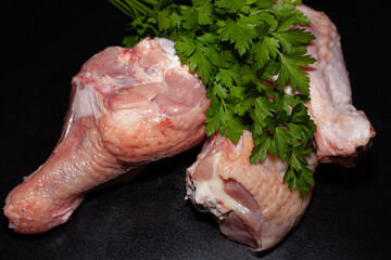 Turkey drumsticks with skin. Organic turkey meat with greens