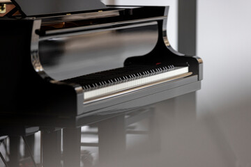 A side view of a gorgeous black grand piano