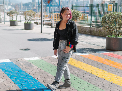 teenager crossing a multicolored zebra crossing