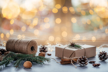 Christmas zero waste packaging gift boxes with pine cones, wooden eco decor and Christmas lights