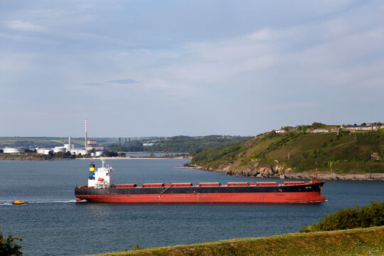 County Cork, Ireland - Jun 2nd, 2020: Bulk carrier ship navigating in Cork Harbour near the village of Crosshaven