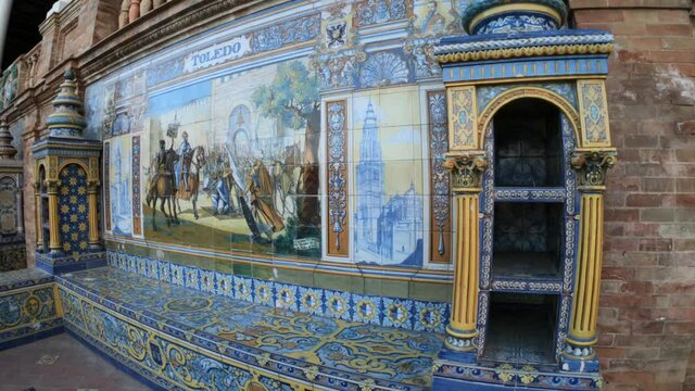 Seville, Spain, September 11, 2021: SLOW - The Spanish Steps in Seville or Plaza de España. The 52 frescos depict all 52 Spanish provinces. The tiles are typical of Andalusia, the so-called azulejos.