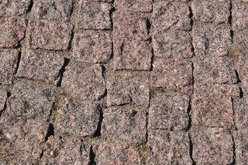 Background, texture of granite stones. The pavement is made of square, granite stones. Background, texture.