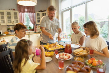 big family at the dinner table .