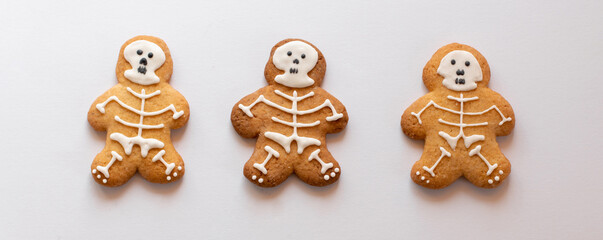Various Halloween gingerbread cookies - skeletons on white background. Halloween concept. Top view.