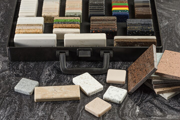 Large selection of stone samples for countertops and floors. Pieces of artificial acrylic stone in...