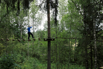Boy overcomes obstacle course in forest