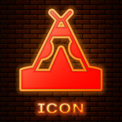 Glowing neon Traditional indian teepee or wigwam icon isolated on brick wall background. Indian tent. Vector © vector_v