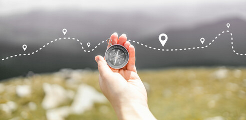 Explorer traveler holds a compass in his hand and searches for directions to the top of the mountain © Shi 