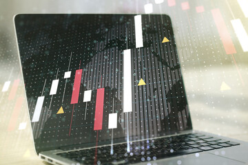 Abstract creative financial graph with world map on modern laptop background, forex and investment concept. Multiexposure