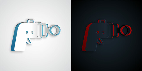Paper cut Ray gun icon isolated on grey and black background. Laser weapon. Space blaster. Paper art style. Vector