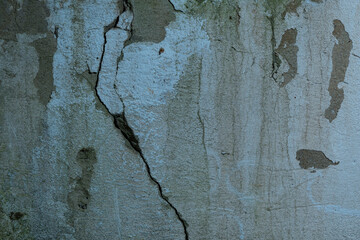 The wall of an old building, with a crack and a beautiful texture. A magnificent background from an old ruined wall. Beautiful and diverse background picture.
