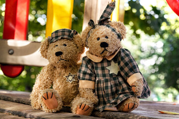 Nazism concept. A family of teddy bears with the Star of David patch on a nature background.