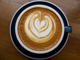 cup of cappuccino top view on the wooden table